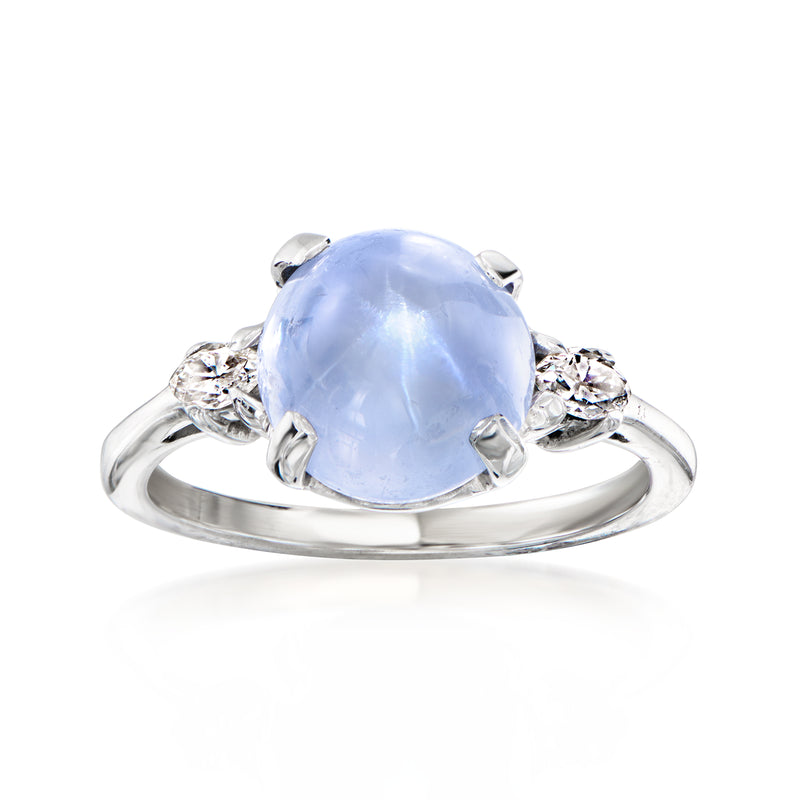 14kt white gold ring with oval blue star sapphire cabochon and diamond accents