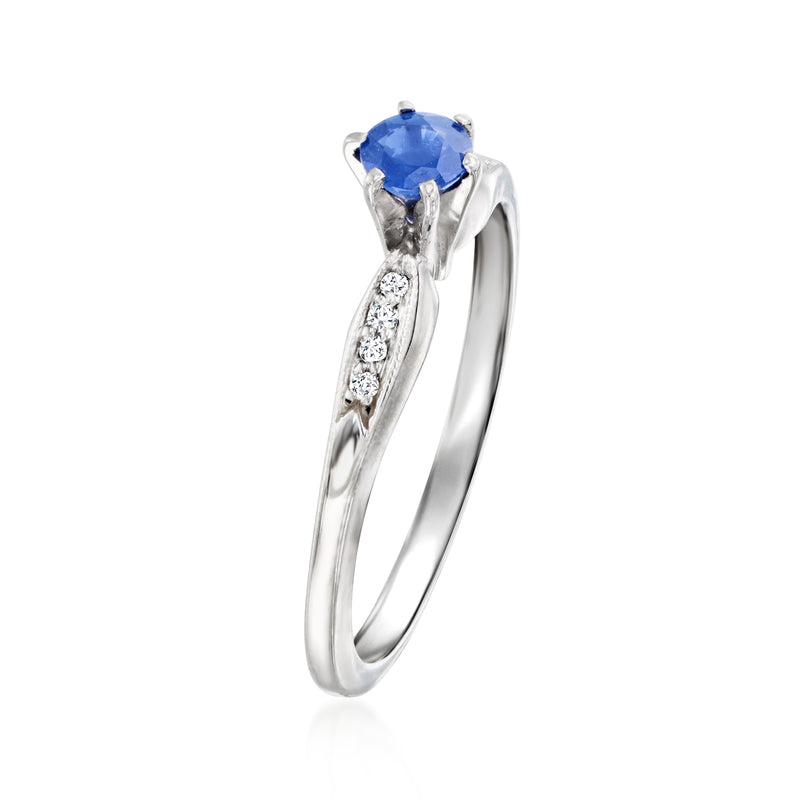 14kt white gold ring with round blue sapphire and diamond accents on the band