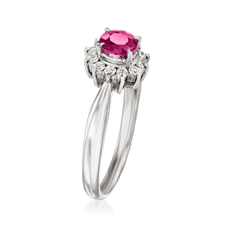 Platinum ruby ring with halo of round diamonds and open split shoulders