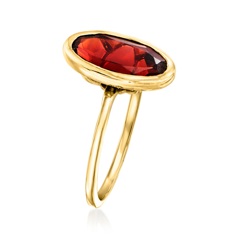 Oval garnet ring in 14kt yellow gold, low bezel with red faceted centerpiece