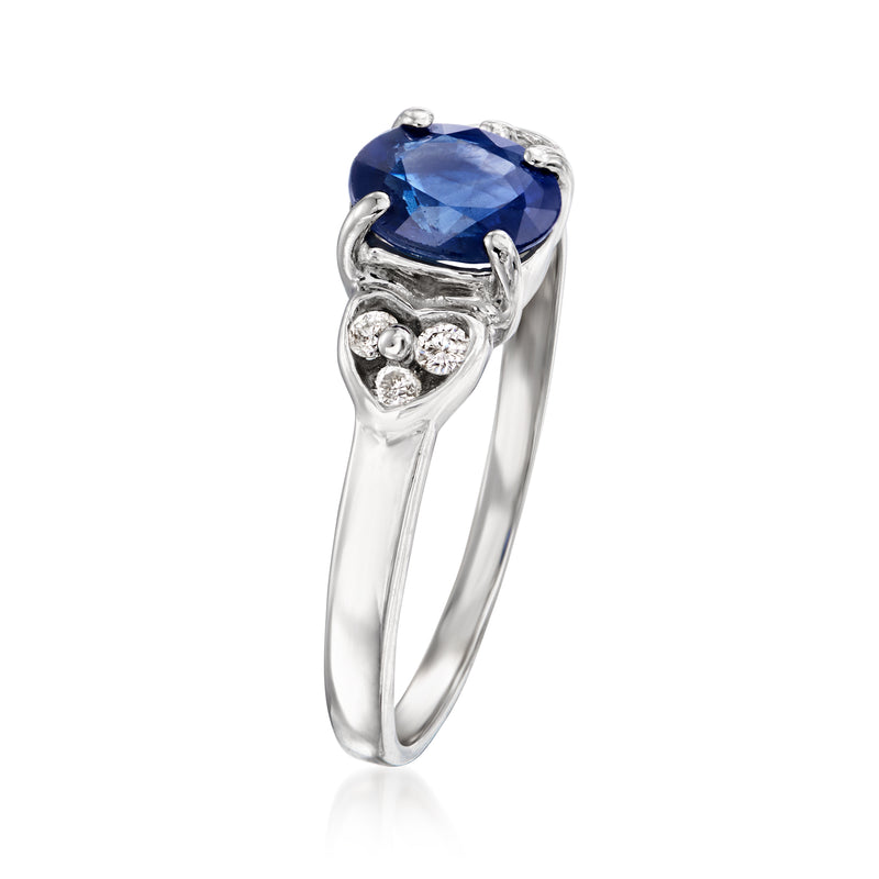 Oval blue sapphire ring in white gold with diamond cluster side settings
