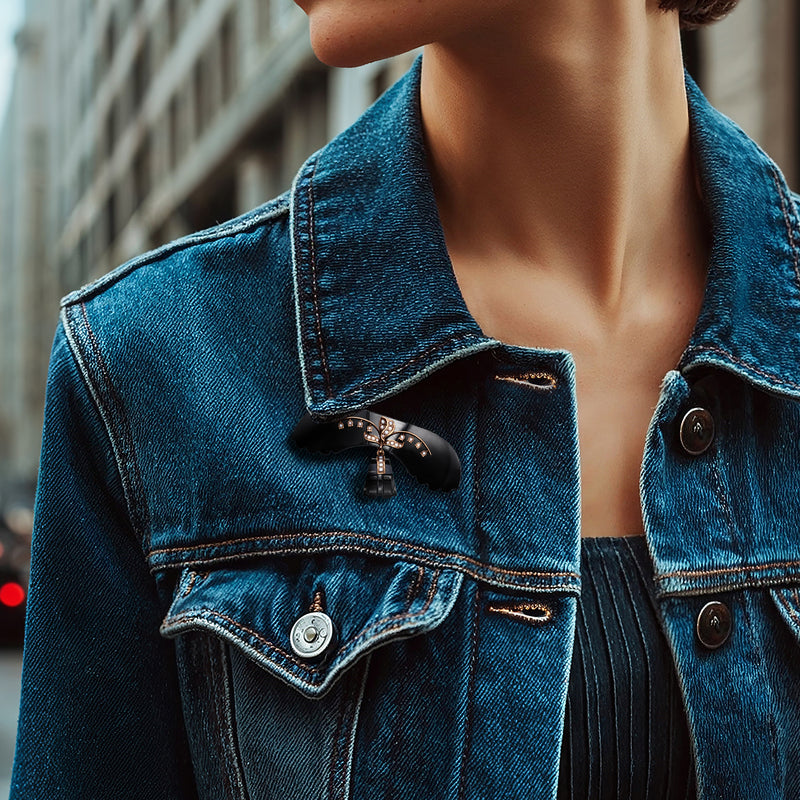 Onyx seed-pearl pin on blue denim jacket, round button detail at center