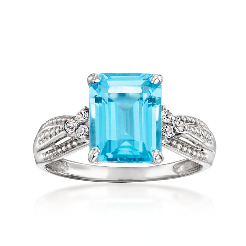 Vintage blue topaz ring with emerald-cut gemstone, prong-set in white gold with side stones