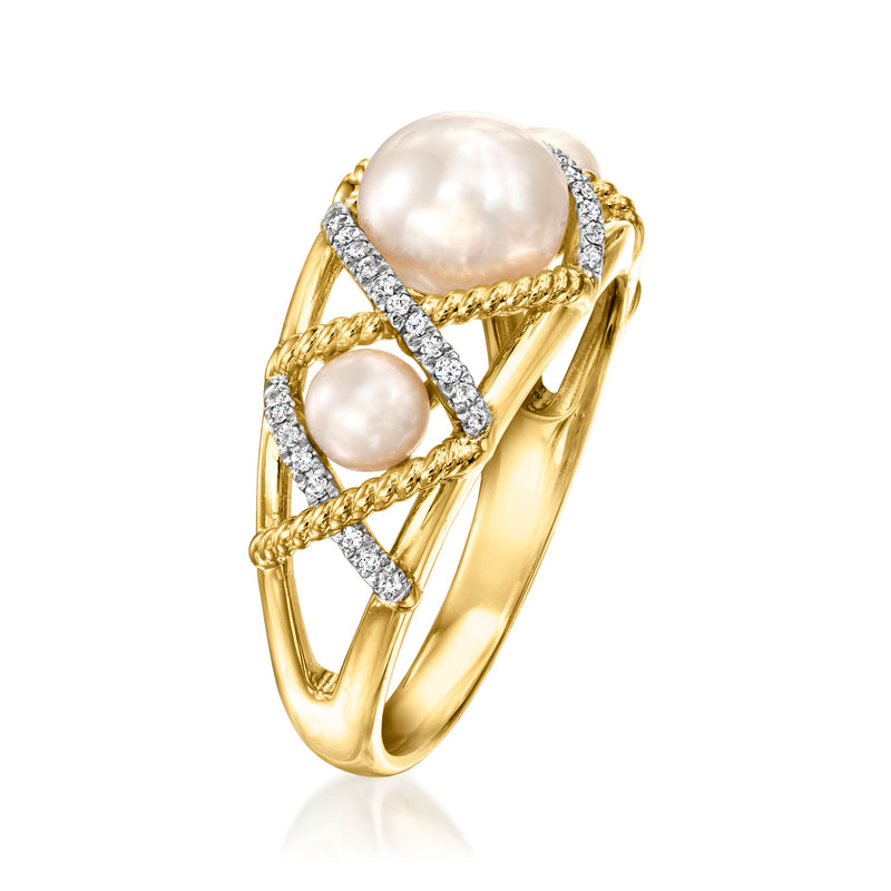 Gold crisscross ring with large center pearl, two side pearls, diamond-like accents