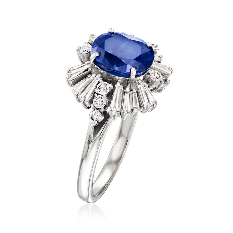 Platinum sapphire ring angled view, blue oval center with baguette and round diamond accents