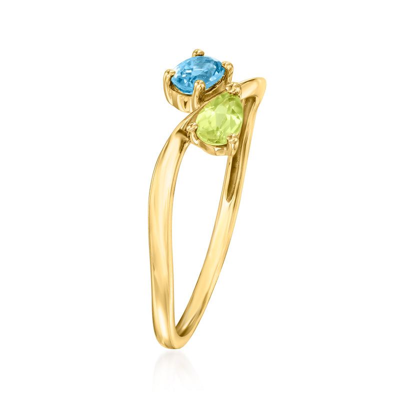 14kt yellow gold bypass ring with blue topaz and green peridot in oval settings