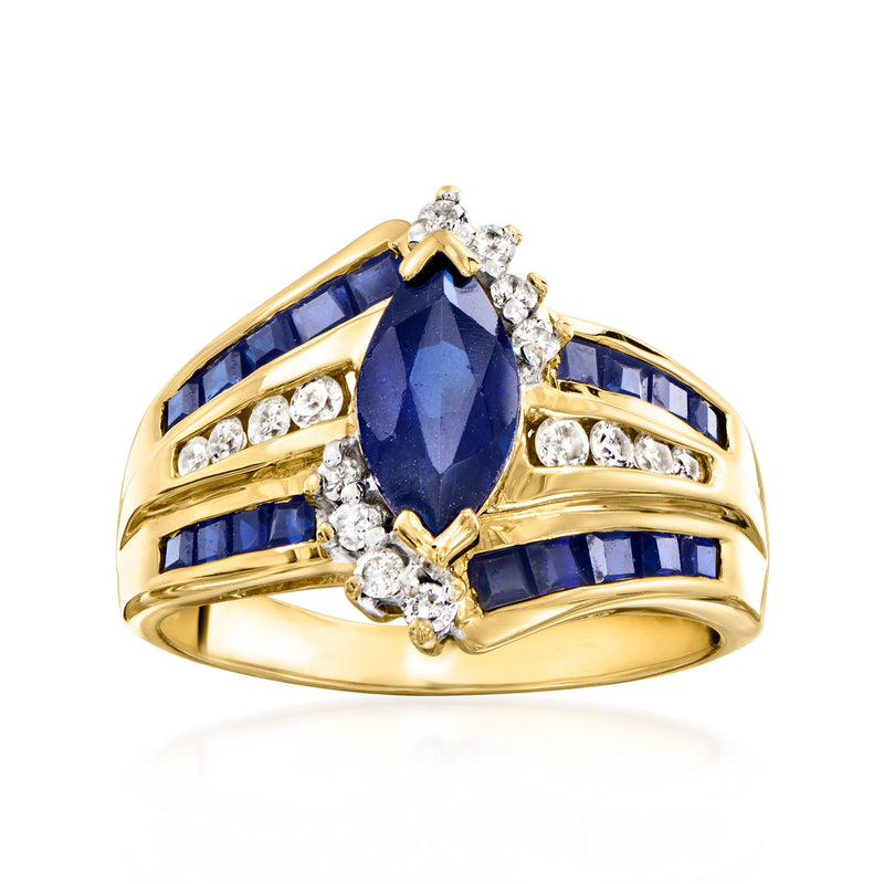 Vintage 14kt yellow gold ring with oval blue sapphire, diamond accents, and blue side stones