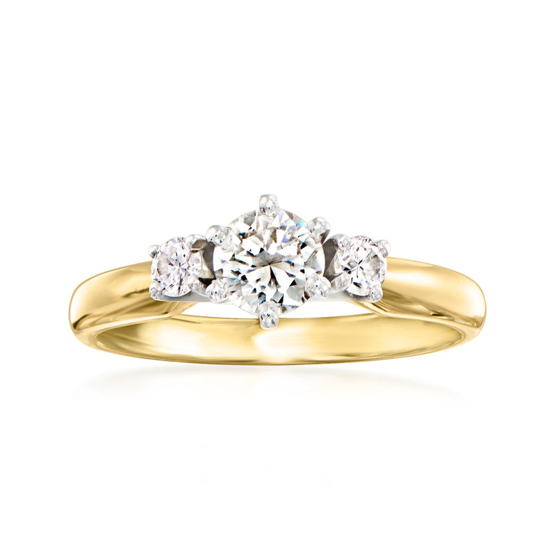 Vintage three-stone diamond ring in 14kt yellow gold with round center and side stones