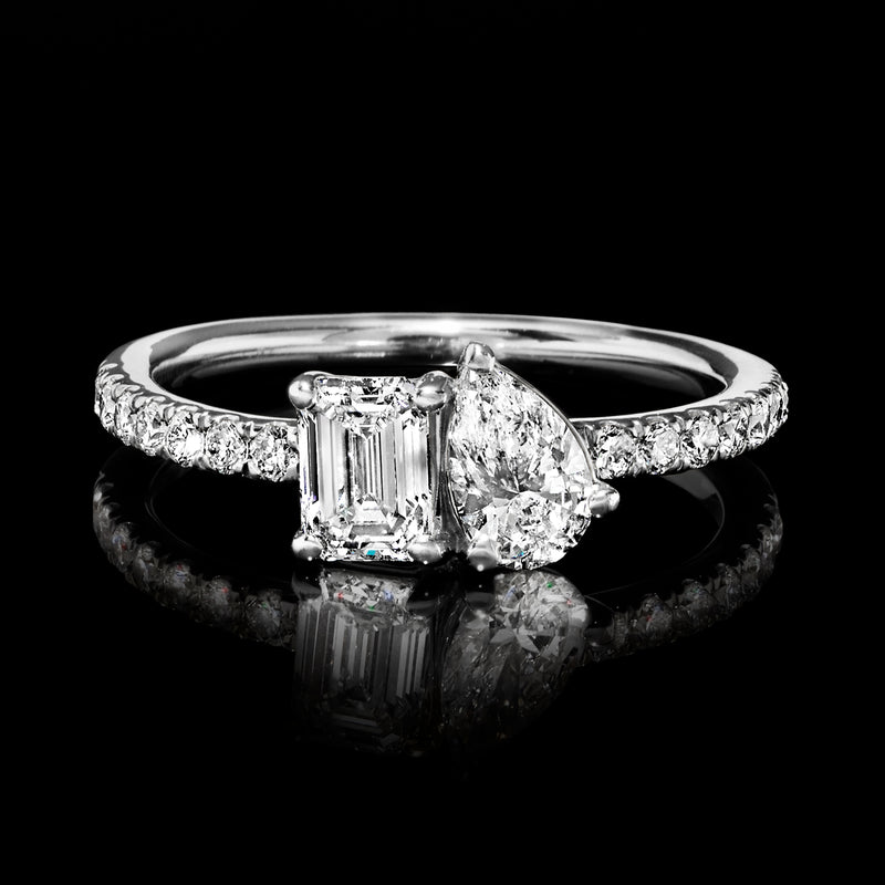 White gold toi et moi diamond ring with emerald-cut and pear-cut stones, pave band