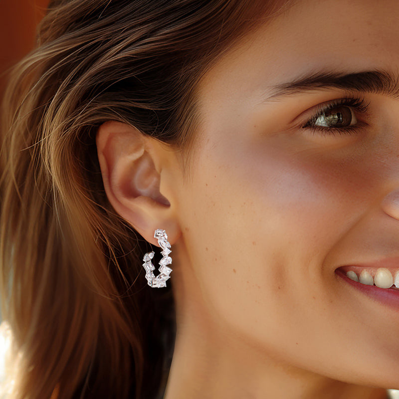 Sterling silver hoop earrings with sparkling CZ bezel clusters, side view