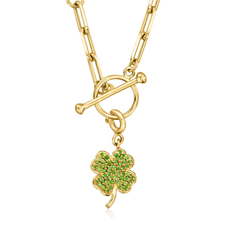 Gold chain with four-leaf clover charm pendant set with green gemstones.