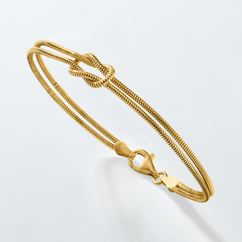 Gold-tone snake-chain bracelet with knotted detail and lobster clasp close-up
