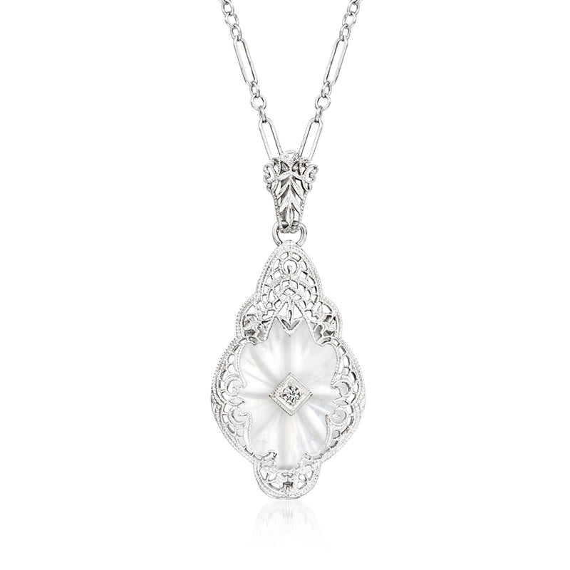 Vintage rock crystal pendant necklace with ornate teardrop setting and diamond center