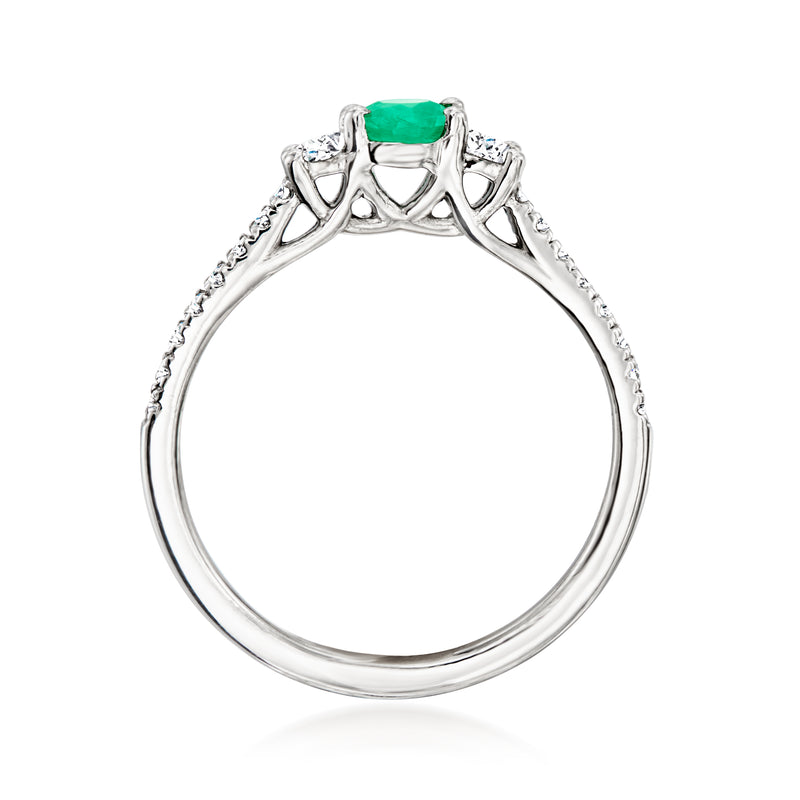 Platinum ring with green center stone framed by diamond accents