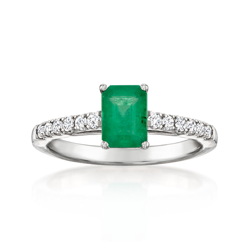 Platinum ring with emerald-cut green gemstone and diamond pave band