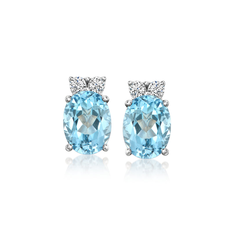 Aquamarine stud earrings in white gold with round blue gems and diamond halos