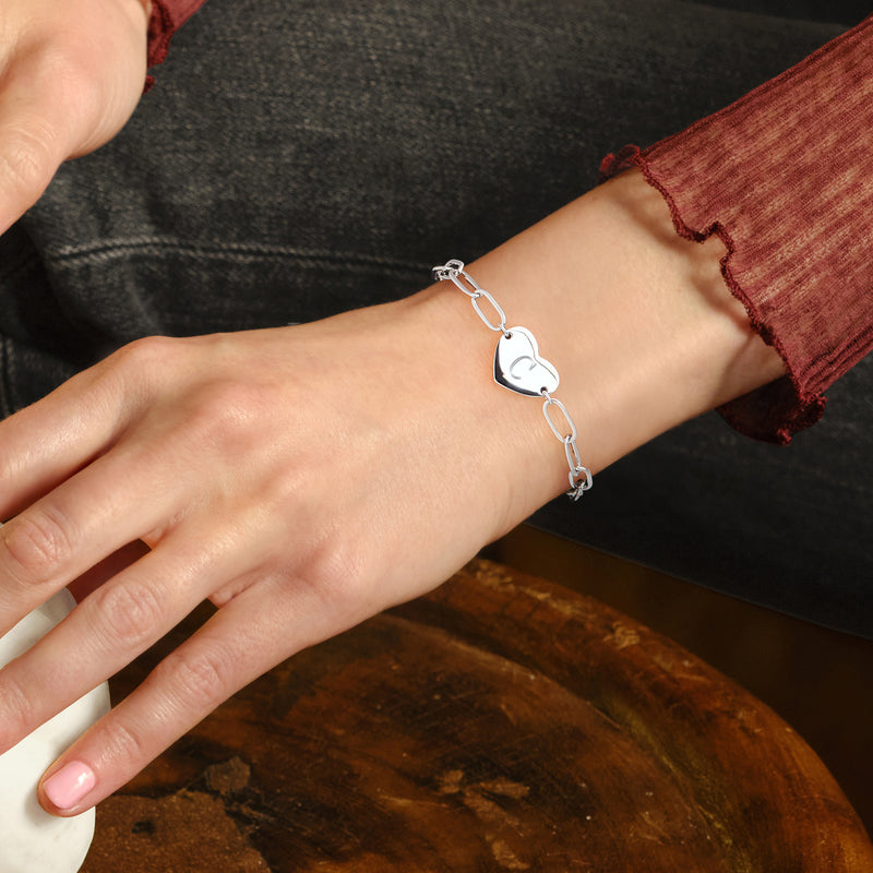 Sterling silver heart link bracelet worn on wrist with small clasp detail