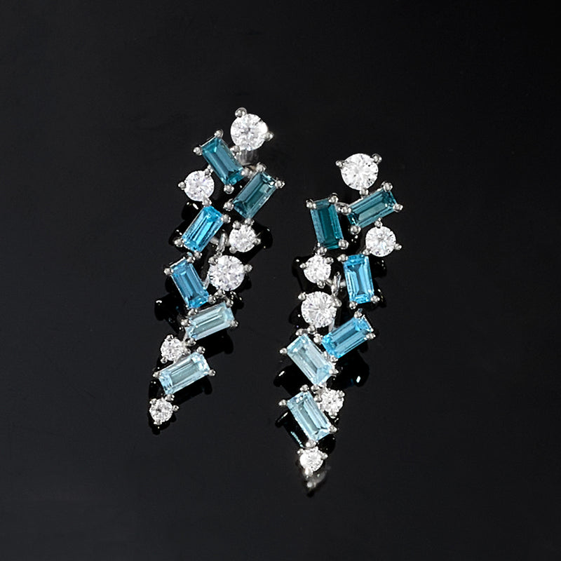 Sterling silver drop earrings with teal baguette stones and sparkling round accents