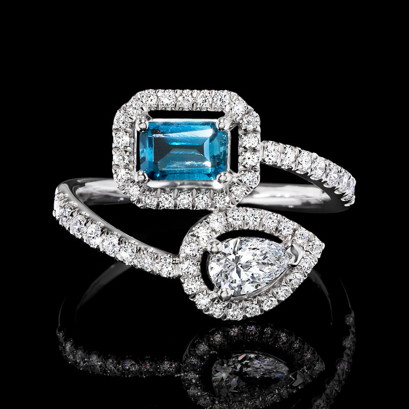 Sterling silver bypass ring showing square blue topaz and marquise-and-round diamond detailing