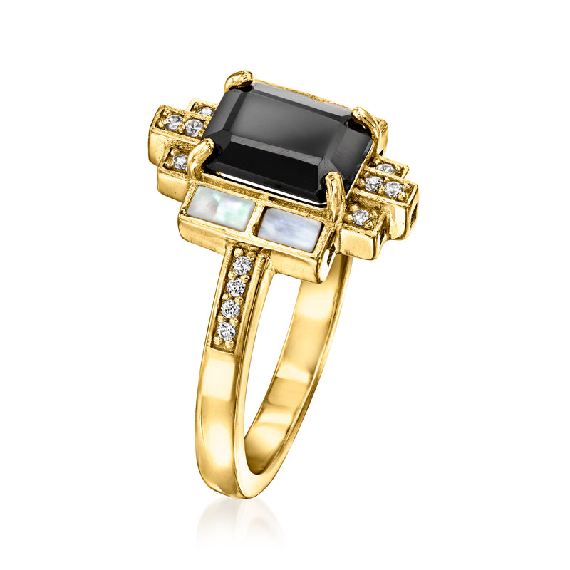 Gold ring with black onyx center, mother-of-pearl accents, and white topaz details