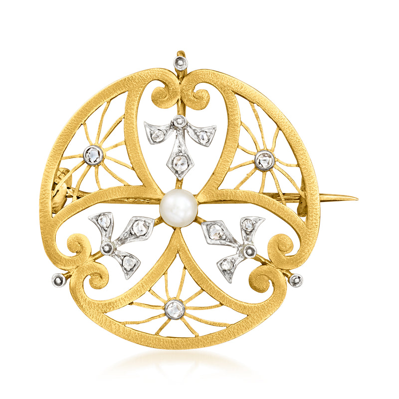 Gold circular filigree pin with white pearl center and small diamond-like stones