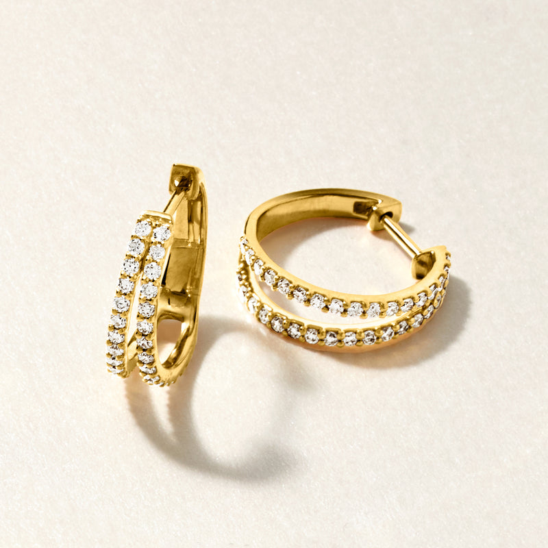 Gold double-hoop earrings with sparkling stone rows and hinged closure