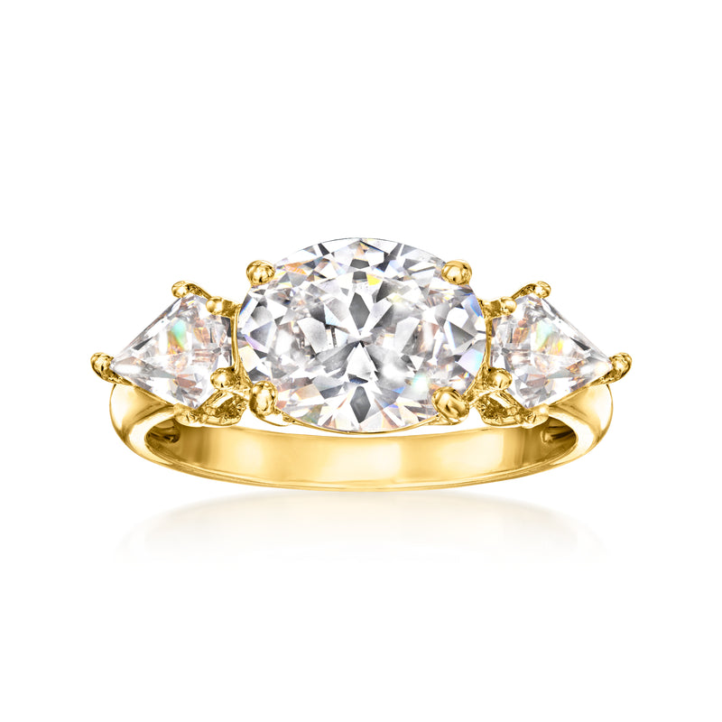 Three-stone CZ ring with central round stone and two side stones, gold-tone band