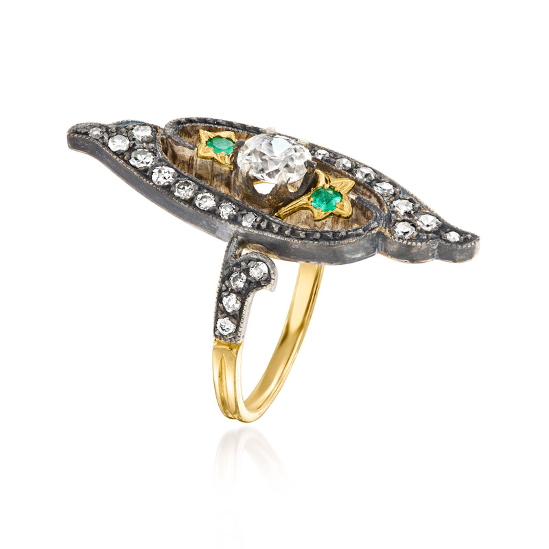 Side view marquise diamond-and-emerald ring with blackened silver frame and yellow band