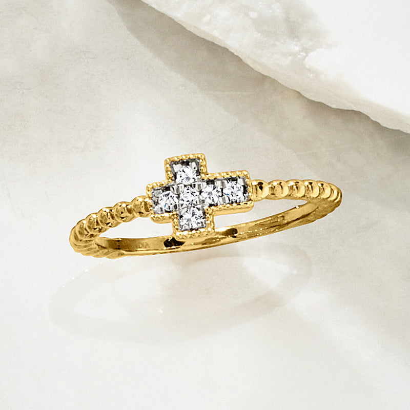 Gold cross diamond-beaded ring viewed from side, showing raised stone cross setting