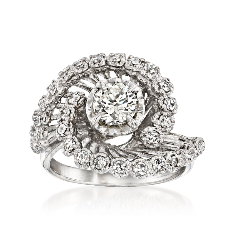 White gold diamond swirl ring with round center stone and halo of small diamonds