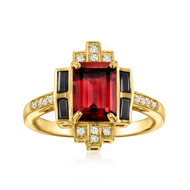 Gold ring with red garnet center, black side stones, and white topaz accents