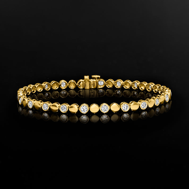 Gold-toned bracelet with alternating round diamond discs and center hinged clasp