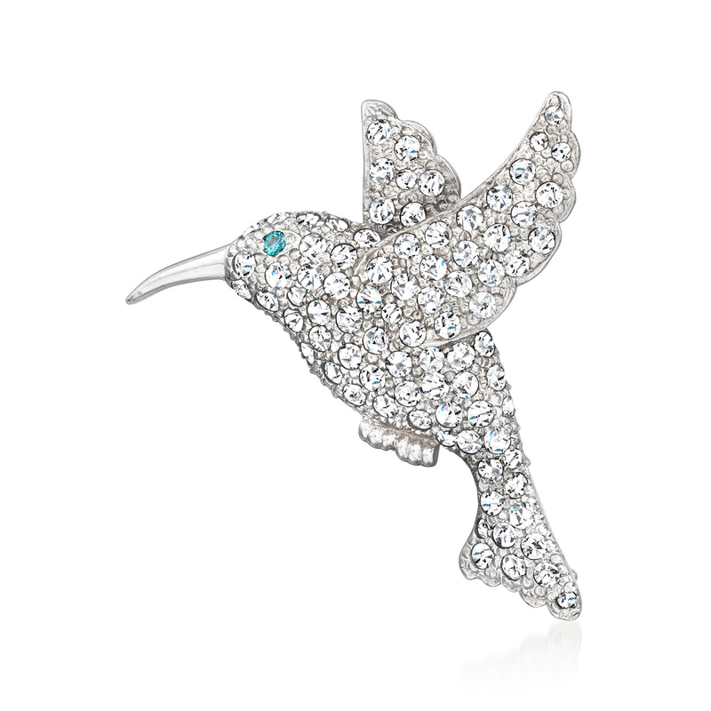 Diamond hummingbird pin in 18kt white gold, jeweled body with blue accent stone