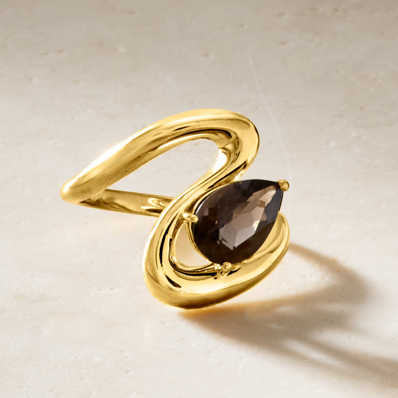 Gold oval smoky quartz ring with sculpted swirl band and prong-set gemstone
