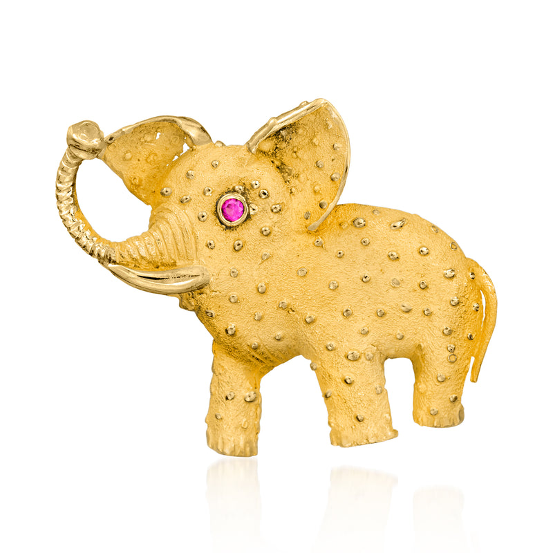 18kt yellow gold elephant pin with ruby eye and textured dotted surface