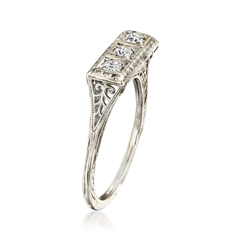 Three-stone diamond ring with ornate filigree sides and square center settings