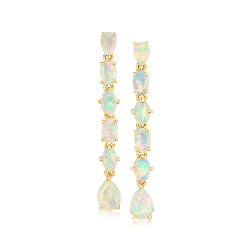 Gold drop earrings with pear-shaped opal-like stones in a vertical line
