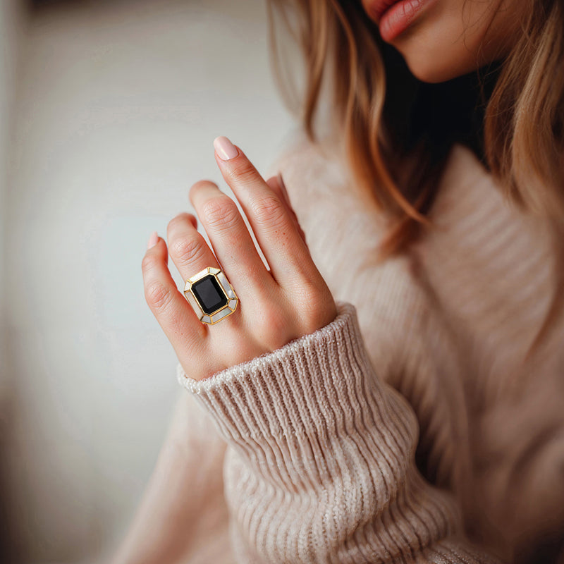 Onyx ring worn on hand, gold over sterling with mother-of-pearl side inlays