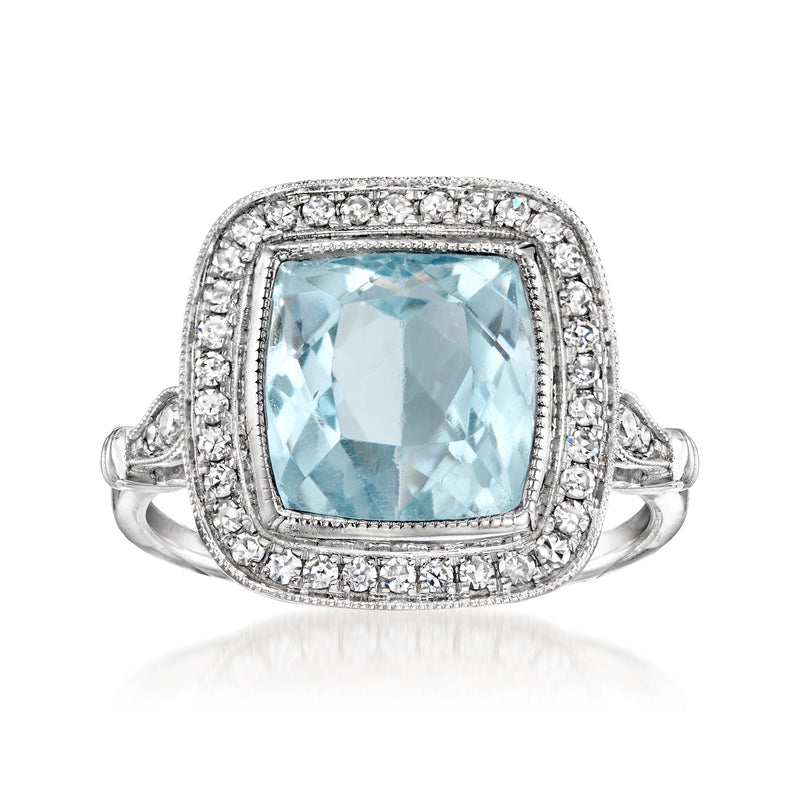 Sky blue topaz cushion ring in 14kt white gold with diamond halo and split band