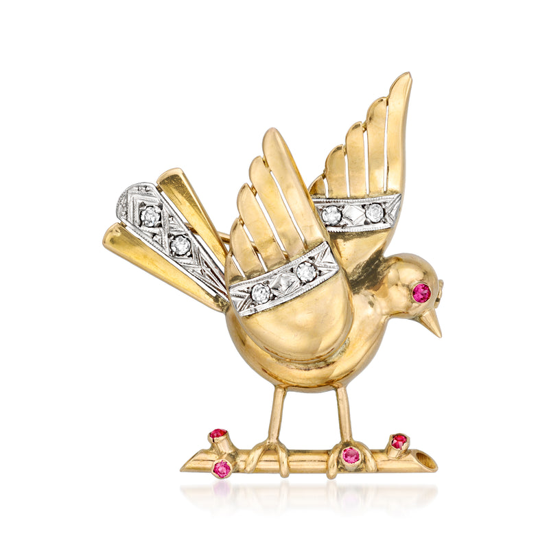 Gold bird brooch pin with sparkling stones, pink ruby accents, and feathered wings