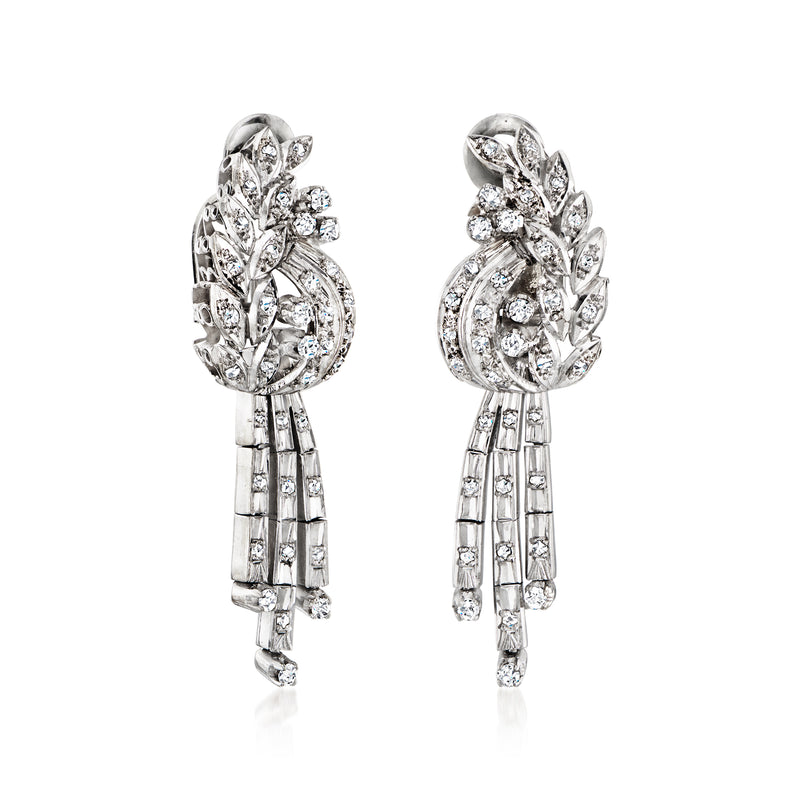 Diamond drop earrings in white gold, side view with curved halo and long tassel drops