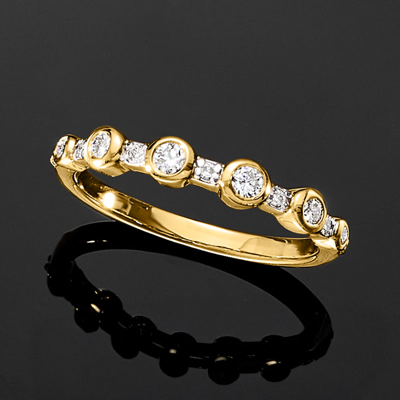 Gold bezel-set lab-grown diamond ring with round stones, angled profile