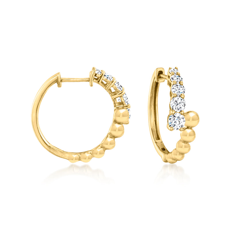 Gold hoop earrings with beaded bypass design and round diamond-like stones
