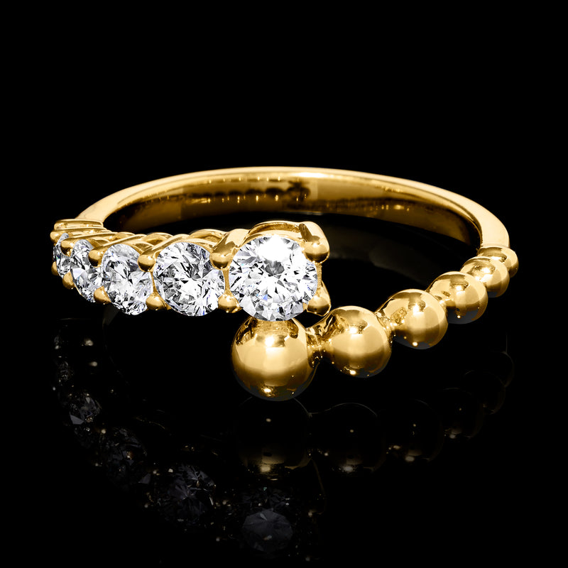 Gold bypass diamond ring with round stones on top and beaded spheres along band