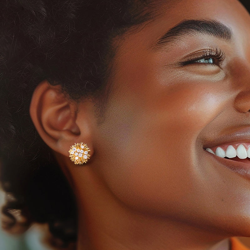 Sunburst diamond stud earrings on ear, small gold rays with round stones