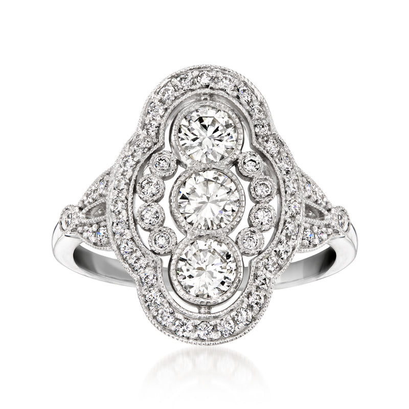 Platinum vintage diamond cluster ring with three round center stones and halo accents