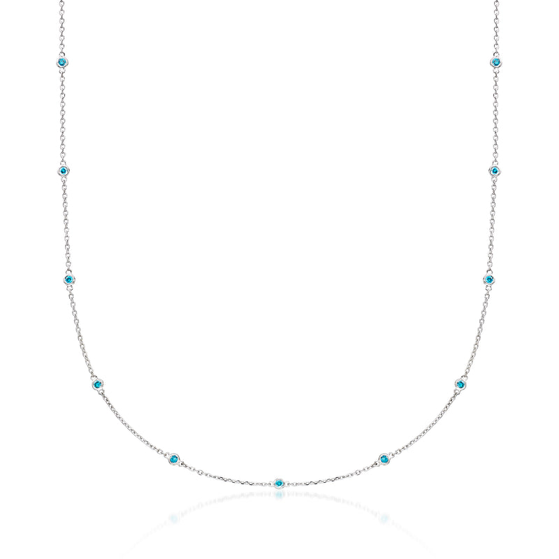 14kt white gold station necklace with small blue diamond accents on a fine chain