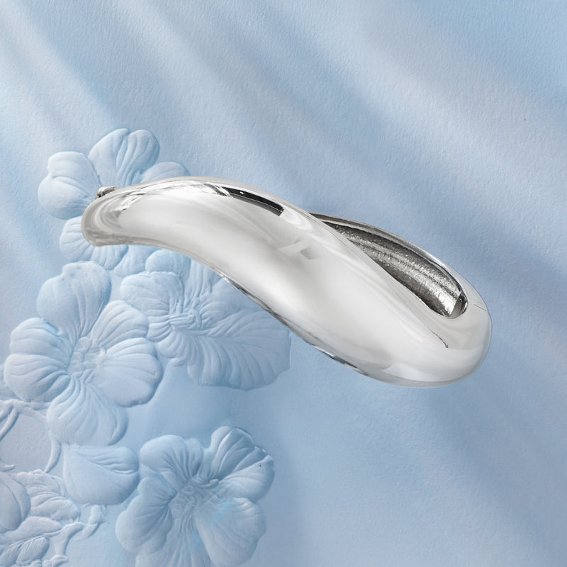 Polished sterling silver sculptural bangle with elongated oval swirl channels