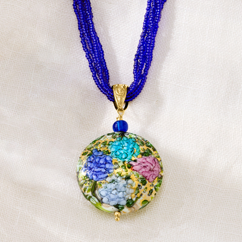 Gold V bail pendant with blue bead and round multicolor glass hydrangea center