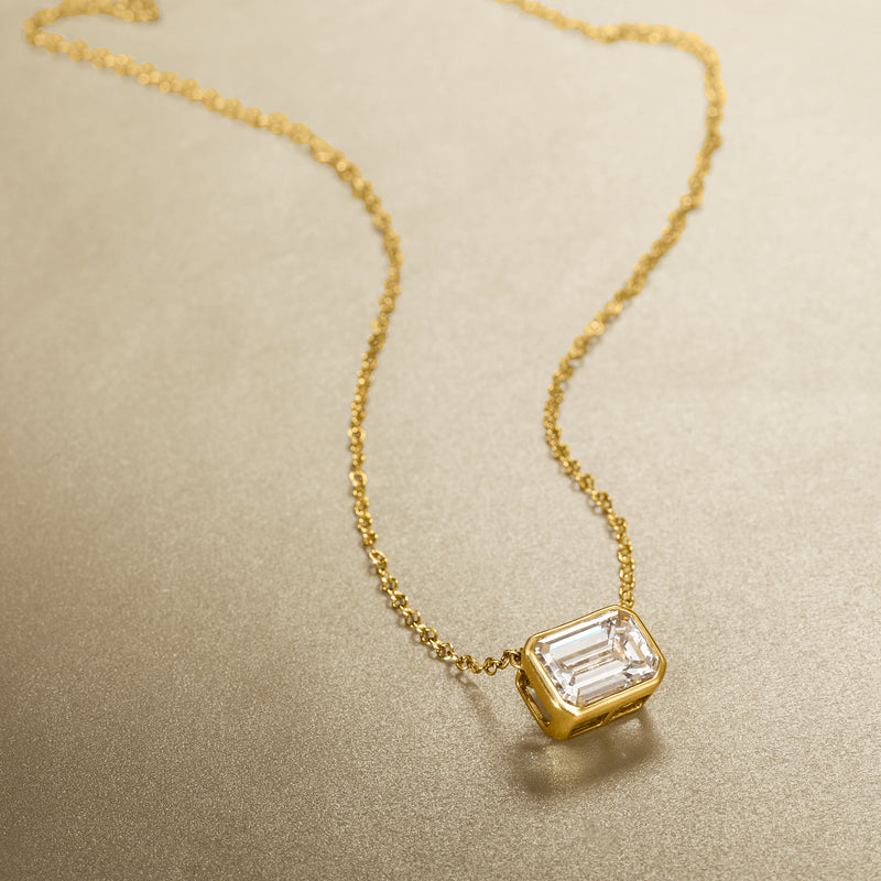 Yellow gold necklace with emerald-cut diamond pendant and small link chain